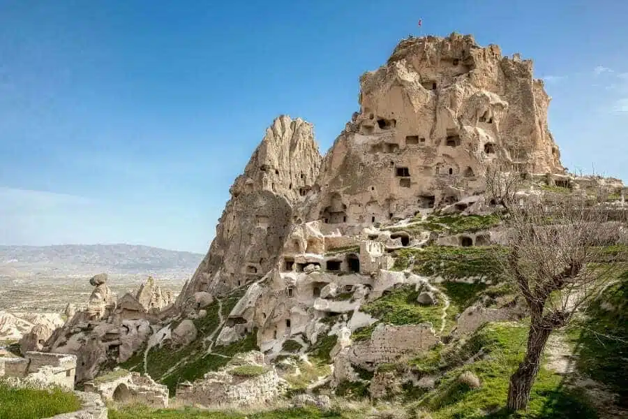 Uchisar Castle in Cappadocia, towering rock formation with carved rooms