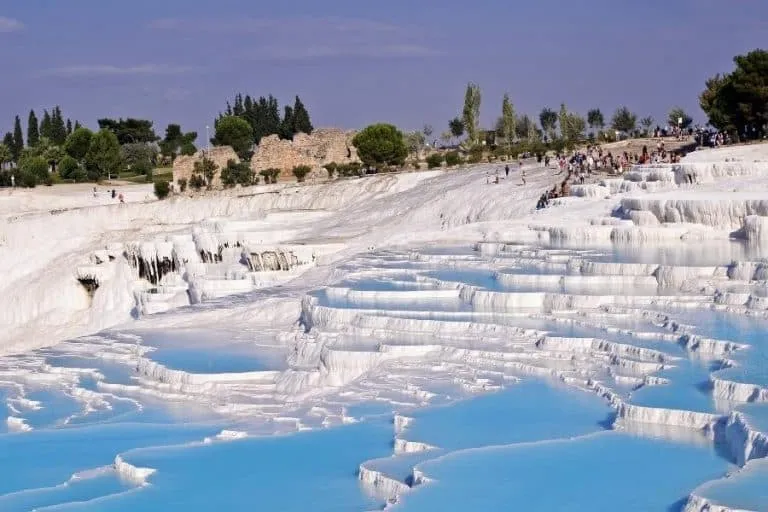 White terraces of Pamukkale Hot Springs in Turkey, reflecting sunlight.