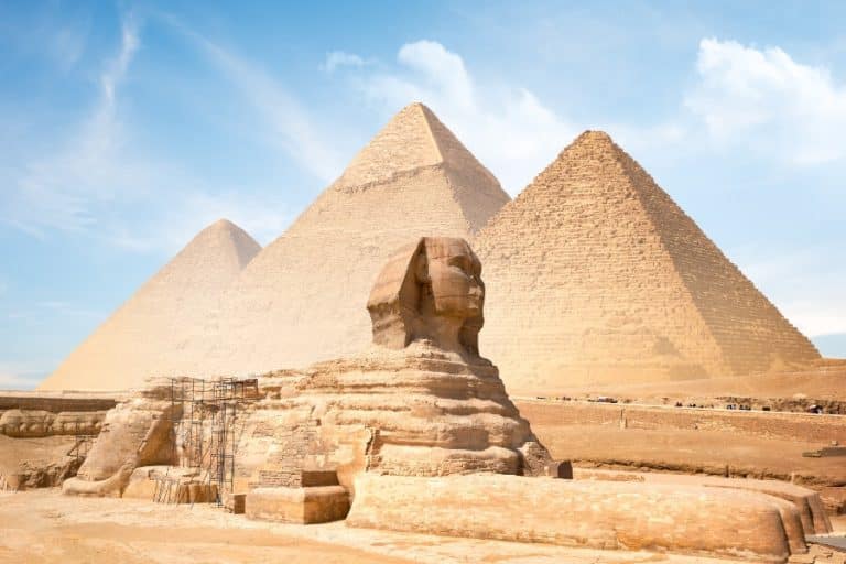 Limestone Great Sphinx of Giza statue under clear sky, showcasing ancient Egyptian craftsmanship.