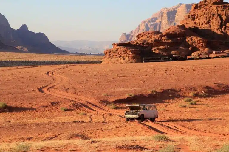 "Safari jeep cruising through the sandy landscape of Wadi Rum.